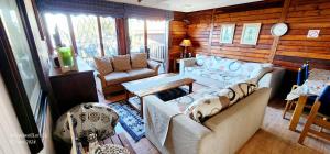 a living room with a couch and two chairs at Milkwood Lodge 10 - Sleeps 4 in Port Edward