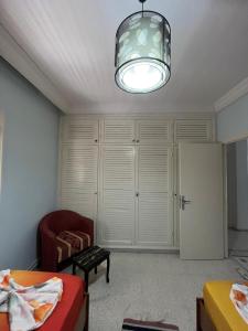 a living room with a couch and a chandelier at Résidence Eddyr in Sicca Veneria