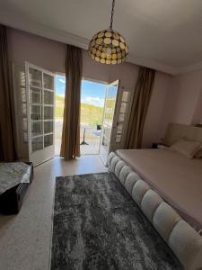 a bedroom with a large bed and a chandelier at Résidence Eddyr in Sicca Veneria