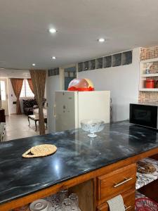 a kitchen with a counter top with a pizza at Résidence Eddyr in Sicca Veneria