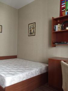 a bedroom with a bed and a book shelf at Hatai Avenue 38 Apartment in Baku