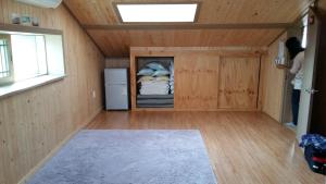 a small room with a refrigerator and a window at Bangdigareum B&B in Seogwipo