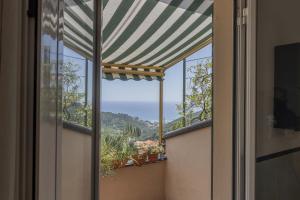 a room with a window with a view of the ocean at Emma House Terrace and Sea View Moneglia in Moneglia
