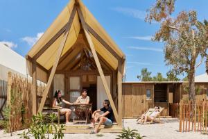 a group of people sitting in a triangular house at TAIGA Delta de l'Ebre in L'Ampolla