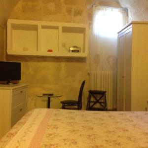 a bedroom with a bed and a table and a window at A Casa di Irene in Matera