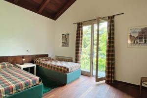 a bedroom with two beds and a window at Casa Micheli - Affitti Brevi Italia in Malgrate