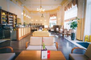 a restaurant with tables and chairs and a bar at BRISTOL Hotel Opatija in Opatija