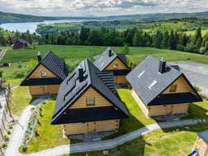 an aerial view of a group of wooden houses at Osada Przystanek Czorsztyn in Czorsztyn