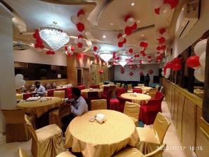 a restaurant with tables and balloons on the ceiling at HOTEL ATHENS , a boutique hotel in Zirakpur
