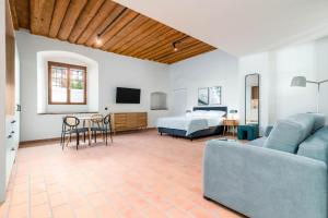 a living room with a bed and a couch at Limehome Krems Undstraße in Krems an der Donau