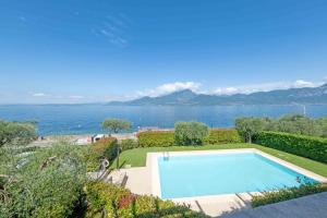a swimming pool with a view of the water at ApartmentsGarda - Il Tesoro del Lago in Torri del Benaco