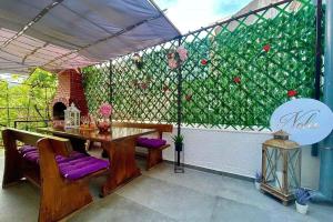 a patio with a table and purple cushioned chairs at Holiday home in Crikvenica 5589 in Crikvenica