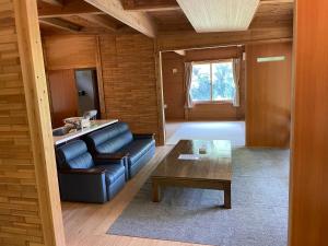 a living room with a couch and a table at YAMAYA BASE 2 in Miyoshi