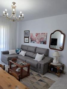 a living room with a couch and a mirror at Casa vacacional amplia in Carracedo