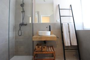a bathroom with a sink and a shower at Hostal Las Acacias in Málaga