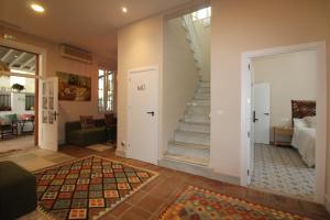 a living room with a stairway leading to a bedroom at Hostal Las Acacias in Málaga