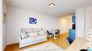 a living room with a couch and a table at Sweetly I-Art Gradignan - Bordeaux Sud in Gradignan