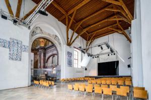 an empty church with chairs and a stage at Limehome Krems Undstraße in Krems an der Donau