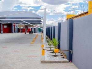 a building with a blue and yellow wall at Okahao Studios Self-Catering in Okahao