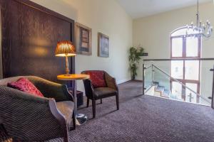 a living room with a couch and a table and a window at The Coach House Hotel in Oranmore