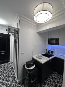 a kitchen with a counter and a sink in a room at Studio Luxury Black & White in Alba Iulia +31 photos
