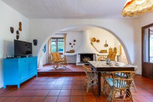 a living room with a table and chairs and a fireplace at Holiday Home Le Sirene in Fort Village