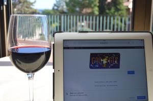 a glass of red wine next to a laptop computer at Hotel Sant Jordi in Tarragona