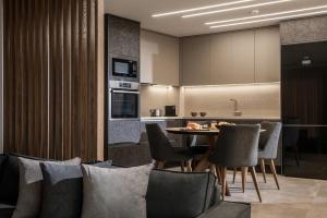 a kitchen and dining room with a table and chairs at Villas Paradise in Kalamaki by South Cretan Villas in Kalamaki +88 photos