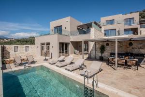 a villa with a swimming pool and a house at Villas Paradise in Kalamaki by South Cretan Villas in Kalamaki