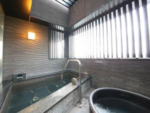 a bathroom with a tub and a large window at APA Hotel Asakusa Kuramae in Tokyo +92 photos