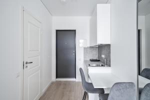 Una cocina con gabinetes blancos y una mesa y sillas. en Central Cozy 1Bedroom Apartment with Sofa Bed - Sleeps 4, en Vilna 17 fotos más