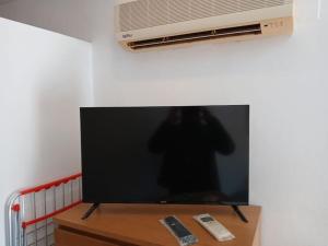 a flat screen tv sitting on top of a table at weforyou Plza España Benalmádena in Benalmádena