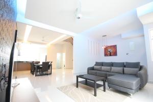 a living room with a couch and a table at Shamrock Beach Villas 9 Seaview in George Town