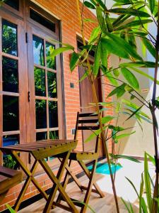 a wooden chair sitting in front of a building at Coffee House Resort Dambulla,Sigiriya in Dambulla +25 photos