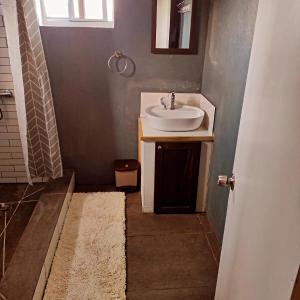 a bathroom with a sink and a shower at 1 Bed Cabin - Sleeps 2 - Wifi in Laborie