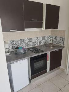 a kitchen with a sink and a stove top oven at Loue studio in Corte +4 photos