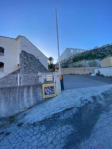 a wall with a sign on it next to a building at Loue studio in Corte