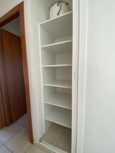 a closet with empty shelves in a room at Loue studio in Corte