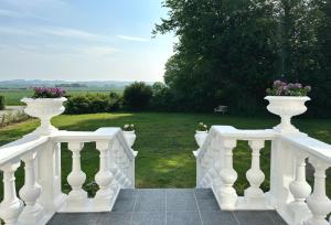 a white stairway with two vases on it at Gundershøj Bed & Breakfast in Ebberup