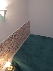 a corner of a room with a bed in a room at Aurette in Saint-Lary-Soulan