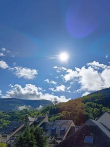 a view of a town with the sun in the sky at Aurette in Saint-Lary-Soulan