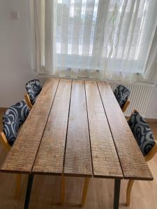 a wooden table sitting in front of a window at Lavender in Postojna