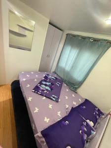 a small bed in a small room with a window at Casă mobilă 1 in Constanţa