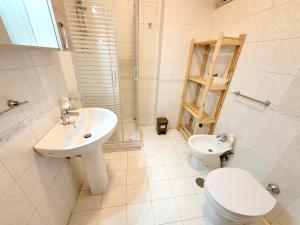 a white bathroom with a toilet and a sink at Casa Mary in Nocera Inferiore