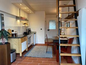 a kitchen with a ladder and a table in a room at dd Chalet in Aitrach