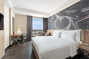 a hotel room with a bed and a painting of an eye at Swiss-Belhotel Airport Jakarta in Tangerang
