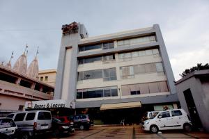 a building with cars parked in front of it at Hotel Platinum Inn in Ahmedabad