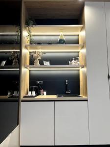 a kitchen with white cabinets and a sink at Rina Apartments in Sarajevo