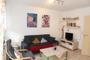 a living room with a couch and a table at Jantje in Norddeich