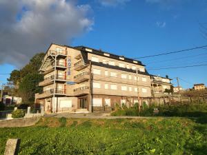 an old building on the side of a street at Hotel Acquamaris 3000 in Sanxenxo